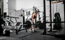 man in orange tank top and black shorts doing exercise
