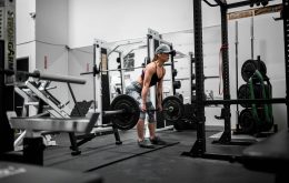 man in orange tank top and black shorts doing exercise