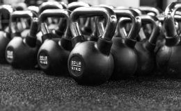 a row of kettles lined up in a gym