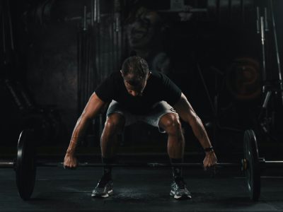 man in black tank top and black shorts doing push up