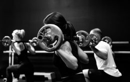 three person lifting barbels