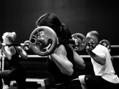 three person lifting barbels