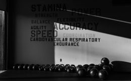 a black and white photo of a row of kettlebells