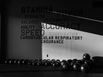 a black and white photo of a row of kettlebells